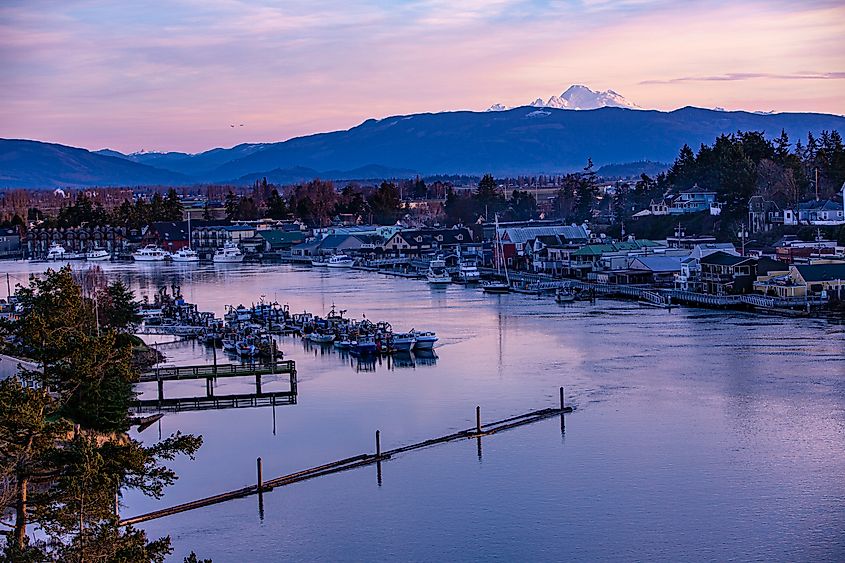 USA, Washington State, La Conner. Swinomish Channel with Mt. Baker in the background.