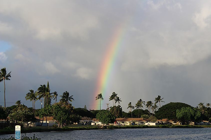 Rainbow over lagoon at Kapilina Beach homes in Ewa Beach, Oahu, Hawaii.