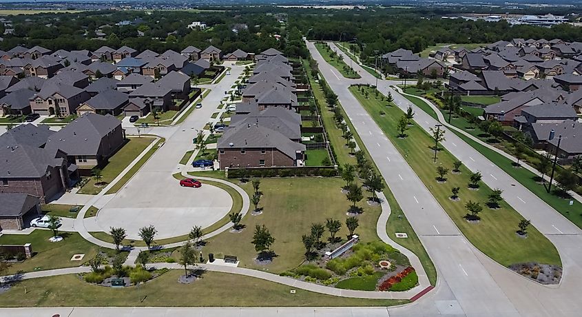 Aerial view of community homes with plants and driveway in McKinney