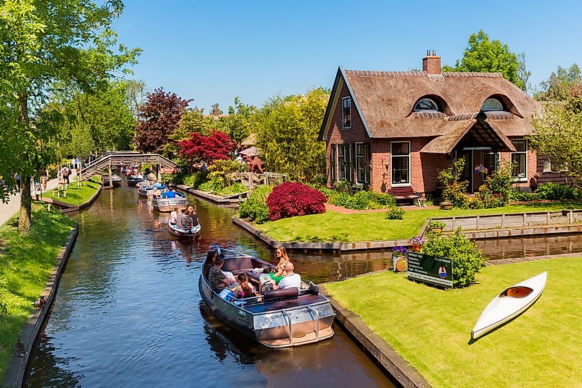 Boats filled with people along the canals in Giethoorn, Netherlands