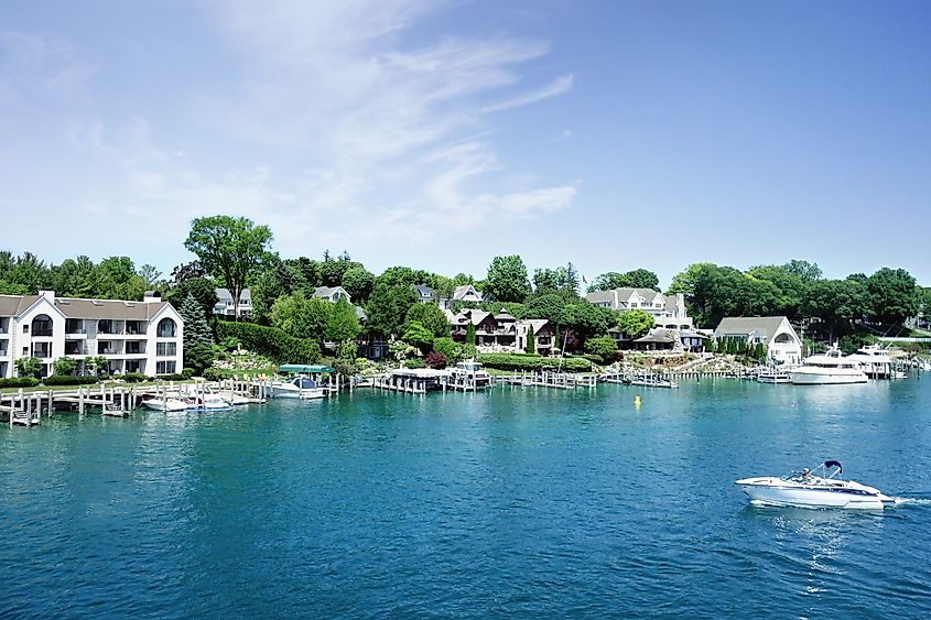 Lakefront homes and boats on the shores of Round Lake in Charlevoix, Michigan.