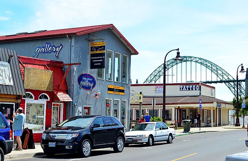 Yieksu via Shutterstock. Newport, Oregon - June 23, 2013 : Front street view of Newport fishing town with Yaquina Bay bridge at the background