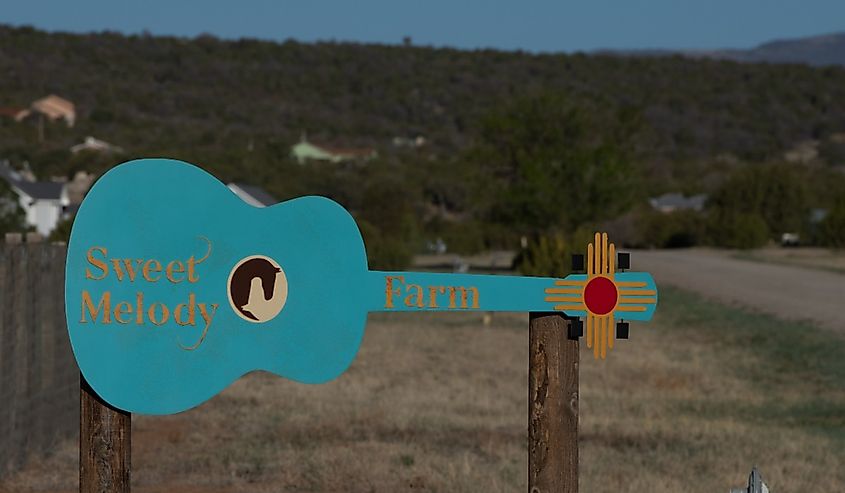 Sweet Melody Ranch and Air B and B with blue guitar and New Mexico four star cross along roadside in Edgewood, New Mexico