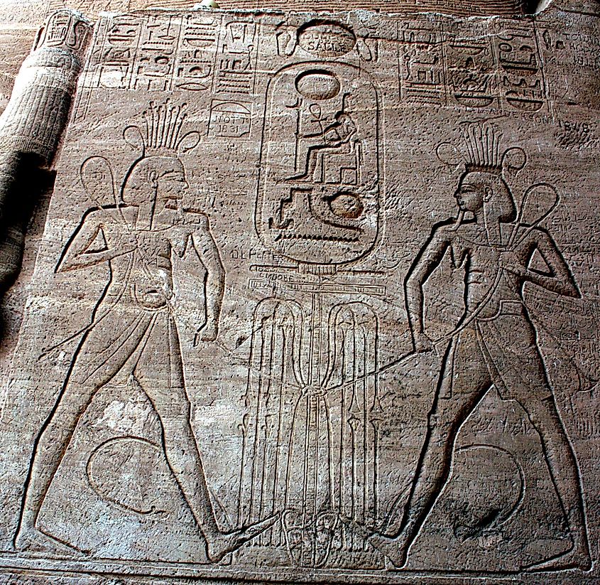 Hapi, the Nile God, tying the papyrus and reed plants in the sema tawy symbol for the unification of Upper and Lower Egypt