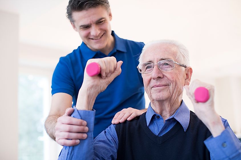 Physiotherapist helping a man exercise