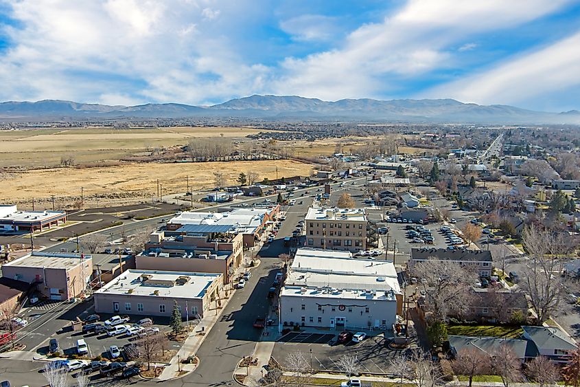 Aerial view of the north side of Carson Valley, encompassing Gardnerville and Minden, Nevada. The cityscape features a mix of residential areas, open farmland, and the surrounding mountains.