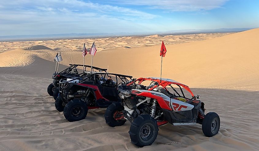 UTV riders parked in the sand dunes, Glamis, California.