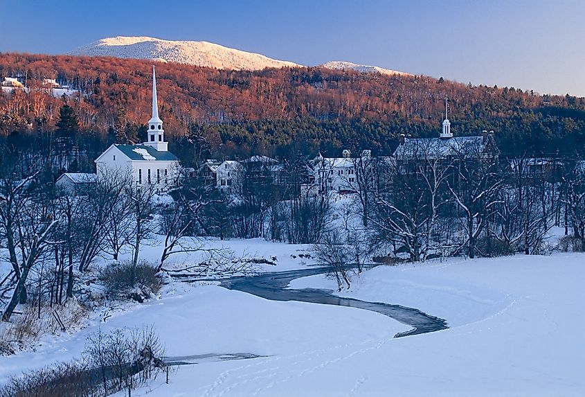 Sunset in the mountains behind the community church in the village of Stowe Vermont, USA.