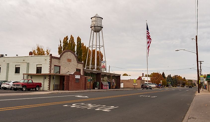 Old water tank and local businesses on Main Street in Merrill, Oregon.