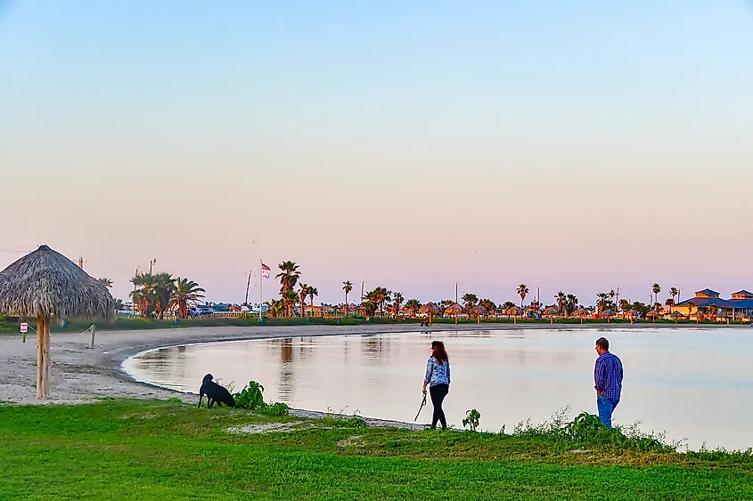 Two people walking along the beach in Rockport, Texas.