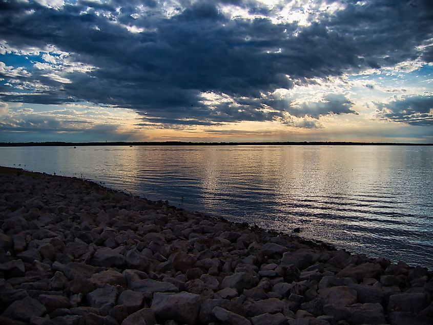 The scenic Hillsdale Lake and its rocky coast at sunset in Kansas.