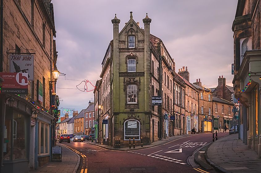 Golden sunset or sunrise light on the village centre and high street of old town Alnwick in Northumberland, England