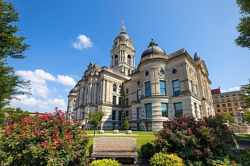 Evansville, Indiana, USA - August 24, 2021: The Vanderburgh County Courthouse with a bench as Civil War Memorial