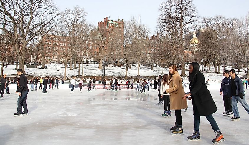 Ice-skating people with white Christmas in Frog Pond at Boston Common in Boston, Massachusetts.