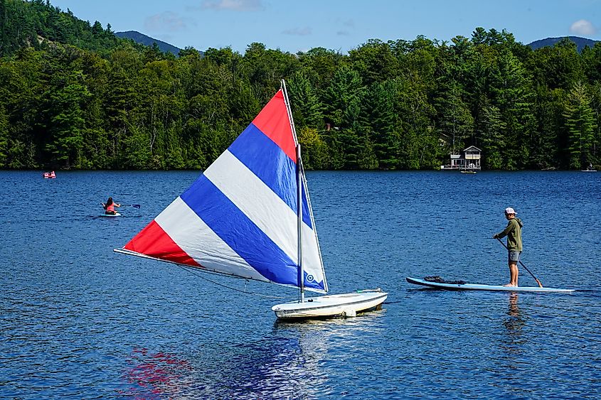 Water boarder enjoys summer day on Mirror Lake in Lake Placid, New York 