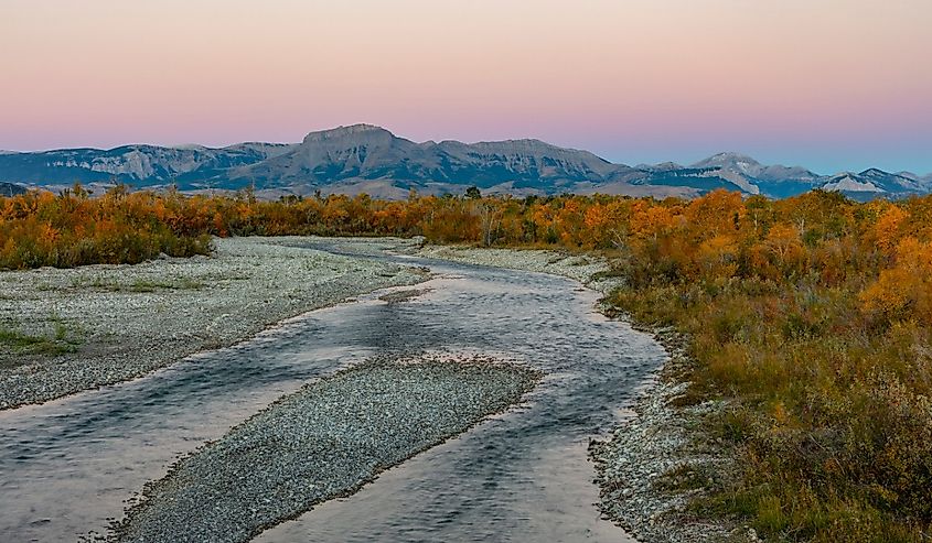 The Teton River with Ear Mountain in autumn at sunrise near Choteau, Montana.