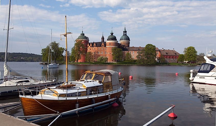  View of the small harbor, boats, and Gripsholm Castle in Mariefred, Sweden.