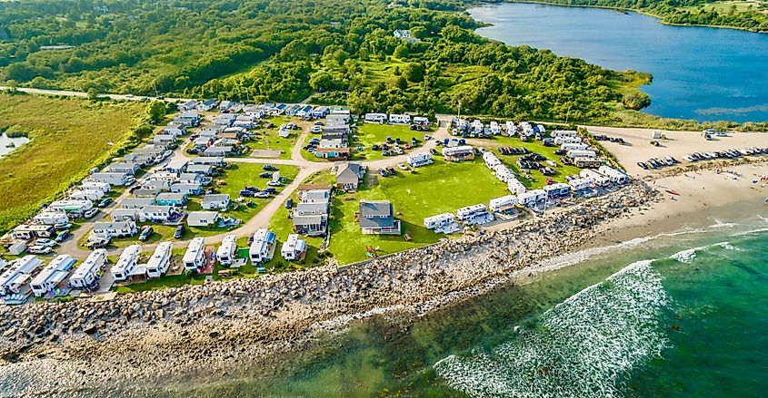 Aerial view of the beachfront campground in Little Compton, Rhode Island, showcasing tents and RVs near the shoreline.