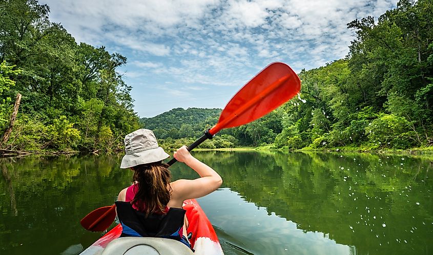 A kayaker is floating down the Buffalo River, Arkansas.