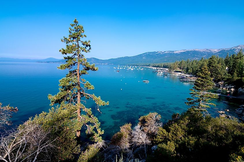 A clear, summer day in Lake Tahoe with views of the clear water and surrounding mountains and forest. Taken near Incline Village, Nevada and Sand Harbor Beach.