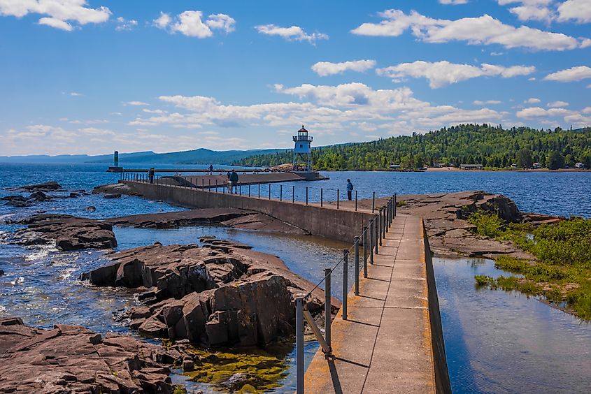 Grand Marais Lighthouse with the Sawtooth Mountains in the background in Grand Marais, Minnesota.