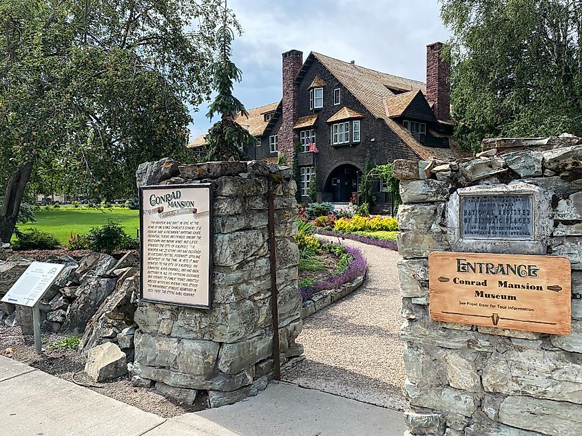 The entrance of a dark stately residence known as the Conrad Mansion.