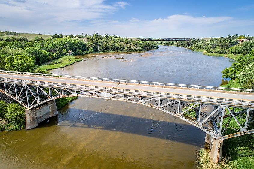 Niobrara River with a historic pin-connected arch Bryan bridge built in 1932 near Valentine in Nebraska