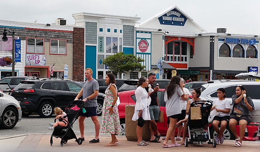 Visitors enjoying the warm summer day on on the street in Bethany Beach, Delaware.