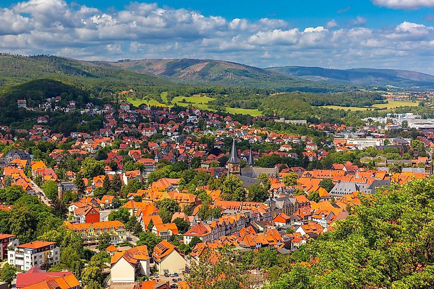 Aerial view of Wernigerode with distinctive red roofs and lush Harz foothills, Germany.