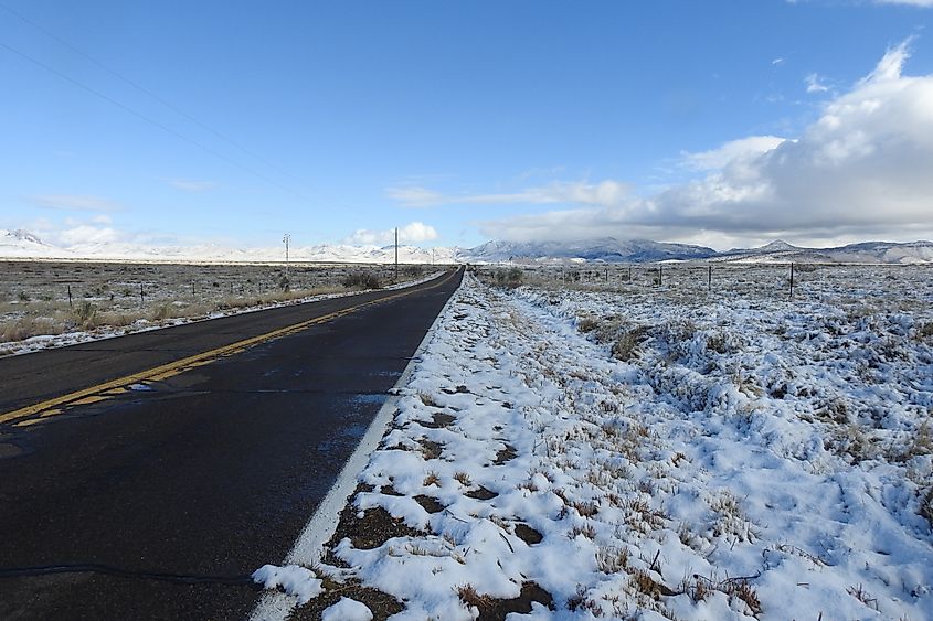 U.S. 191 in Arizona after a winter snowfall, with snow covering the surrounding landscape