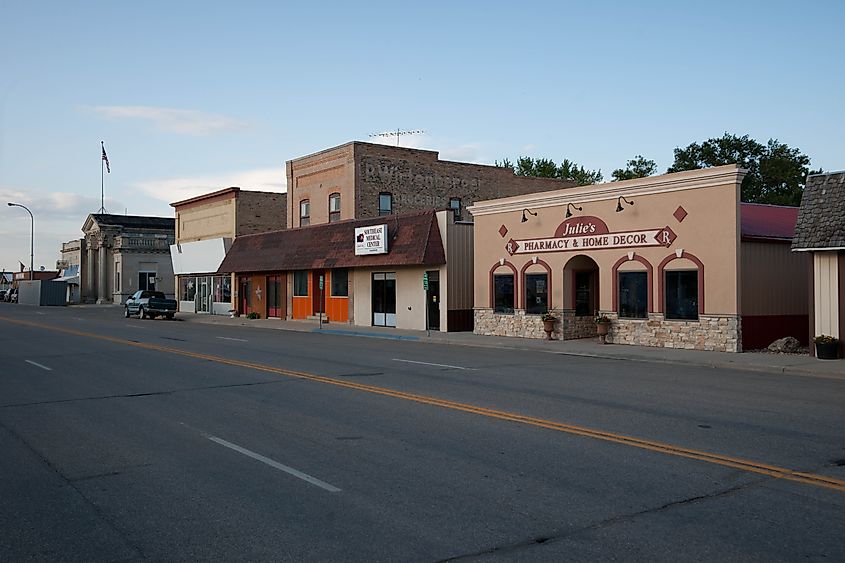 Street view of Lidgerwood, North Dakota, showing a small-town setting with wide streets, local businesses, and historic brick buildings.