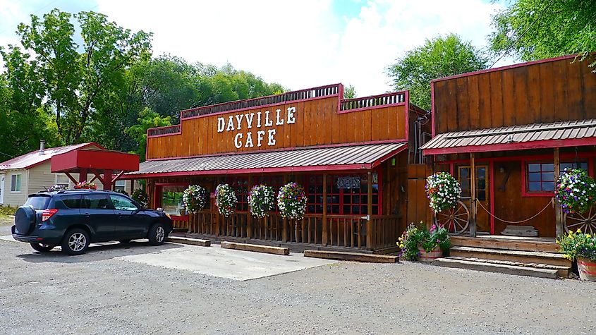 Street view of a café in Dayville, Oregon, showcasing a small-town atmosphere with the café's rustic exterior, surrounded by quiet streets and scenic rural surroundings.