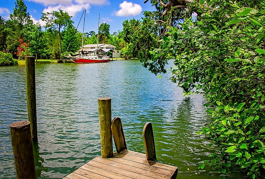 A pier looks out over the Magnolia River at Magnolia Landing in Magnolia Springs, Alabama.