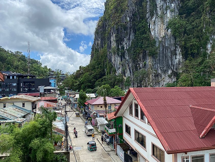 A sheer limestone cliff looms over the small Filipino tourist town of El Nido on Palawan.