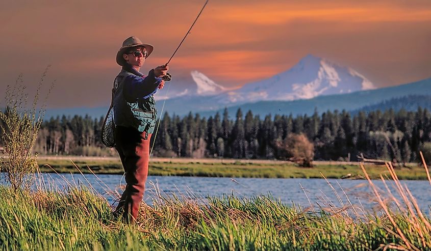 Fly fishing in a small lake in Central Oregon with the Three Sisters Mountains in the background