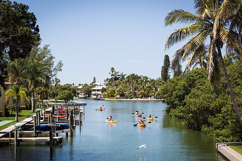 Kayakers floating in a canal on Anna Maria Island, Florida.