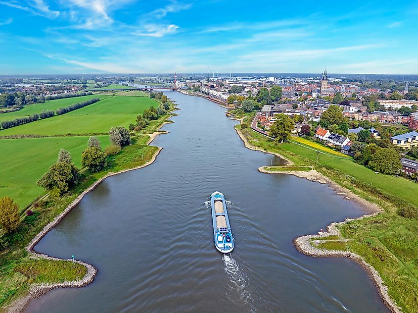 Cargo ship cruising on the river IJssel near Zutphen in the Netherlands