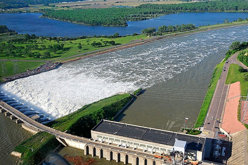 An aerial view shows water gushing through the gates of a dam causing the Missouri River to flood in Dakota Dunes, South Dakota.