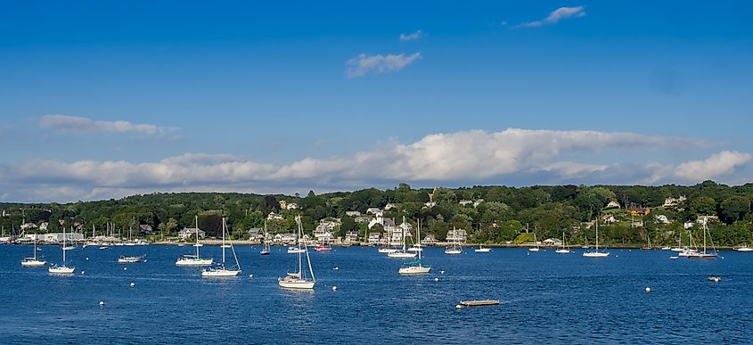 Tiverton, Rhode Island: Coastal scene with sky, beach, boats, and architecture.