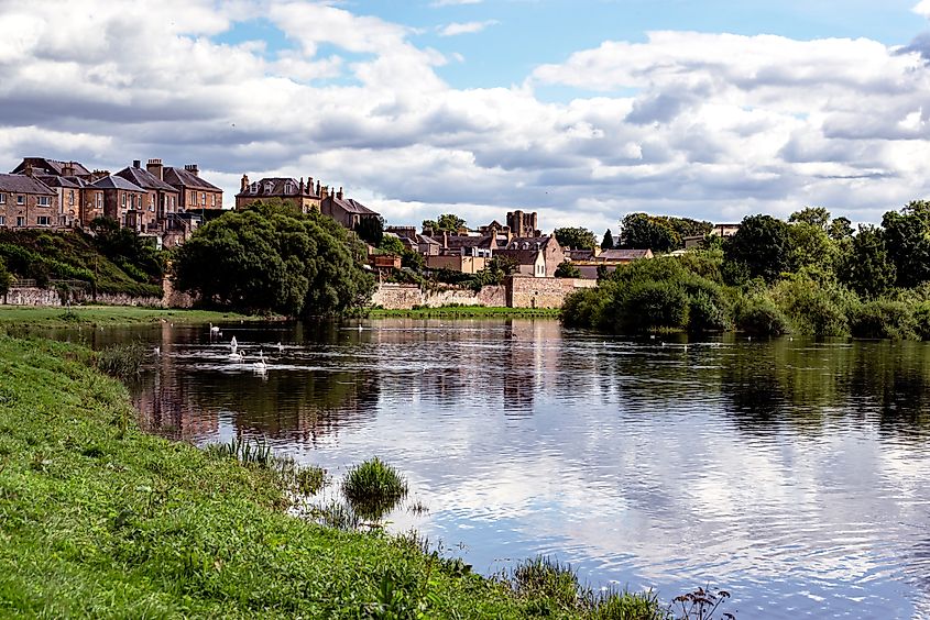 Kelso, a market town in the Scottish Borders, features a charming town square with historic buildings, set along the River Tweed.