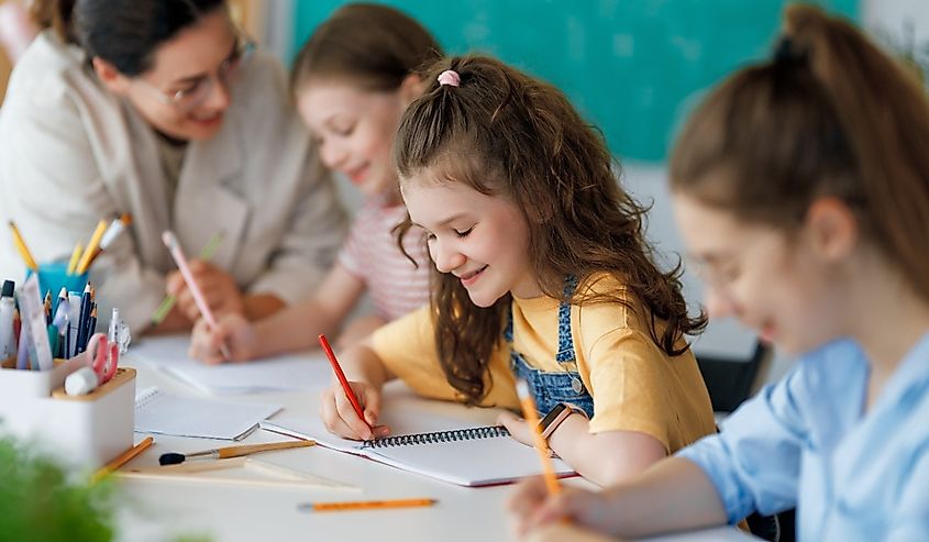 Happy kids and teacher at school