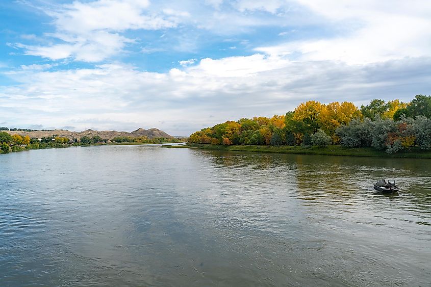 Missouri River in Fort Benton, Montana with boat floating down the river.