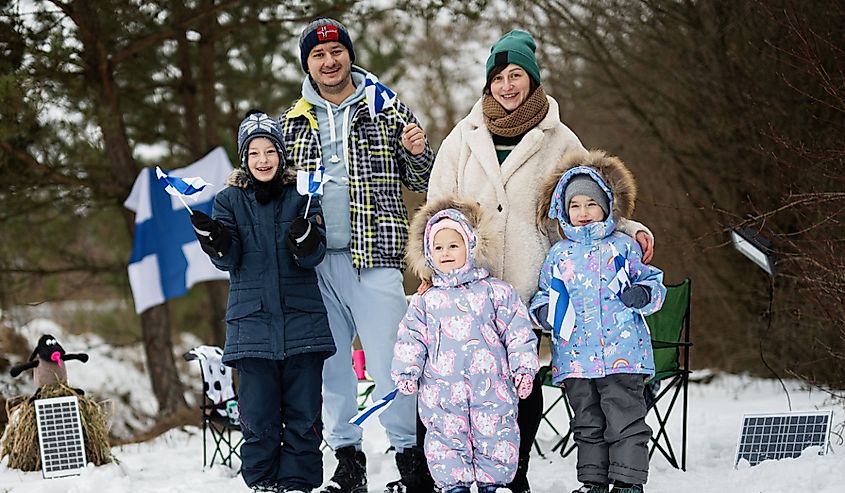 Finnish family with Finland flags on a nice winter day. Nordic Scandinavian people.