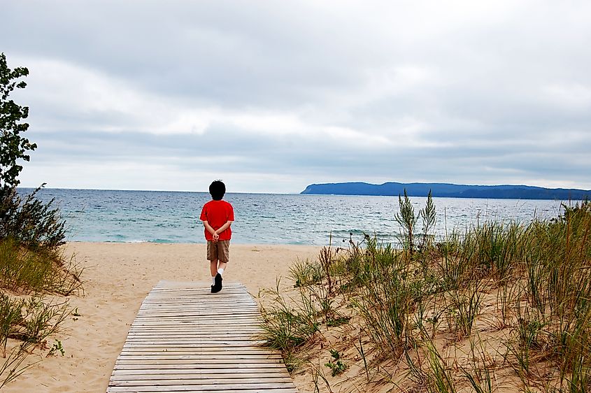 A child enjoying the spectacular view of Lake Michigan at Leelanau State Park, Michigan.