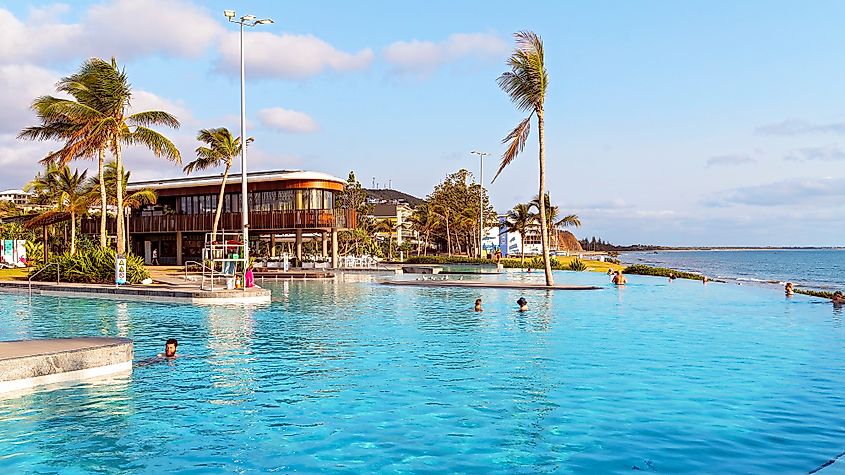 Early morning swimmers at the lagoon with infinity edge pool on the beach, a public recreation area, in Yeppoon, Queensland, Australia. Editorial credit: Jackson Stock Photography / Shutterstock.com