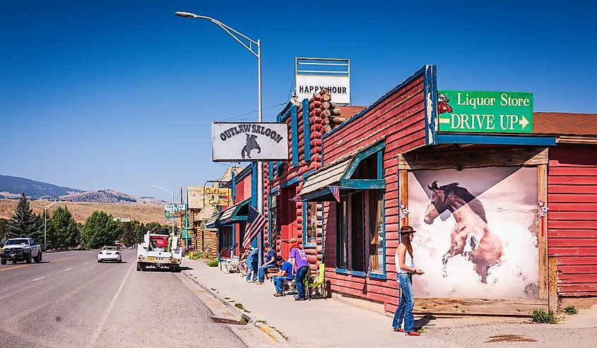 Exterior of Outlaw Saloon with view of street and mountains in Dubois, Wyoming.