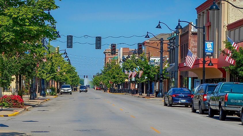 View of Main Street in downtown Belleville, Illinois, lined with historic brick buildings on a summer day.