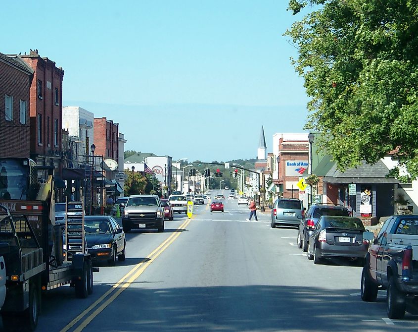 Street view of Abingdon, Virginia, featuring historic buildings, local shops, and tree-lined sidewalks in a charming small-town setting.