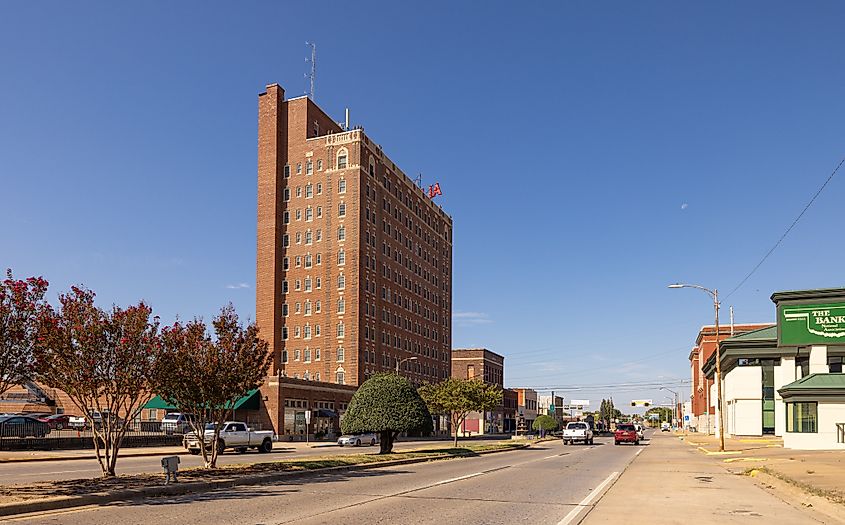 Downtown McAlester, Oklahoma, as seen on Carl Albert Parkway, featuring local businesses and storefronts.