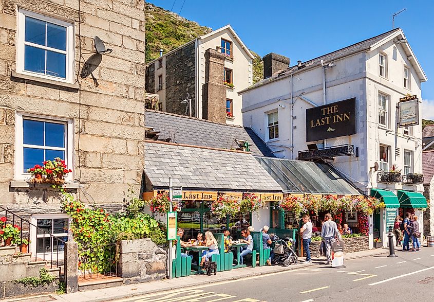 27 July 2016: Barmouth, Gwynedd, Wales, UK - The Last Inn, people eating and drinking outside.